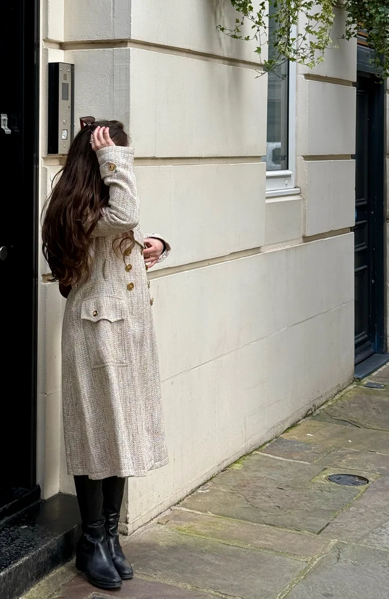Backstage study — a coat, a mirror, a notebook on a worktable.